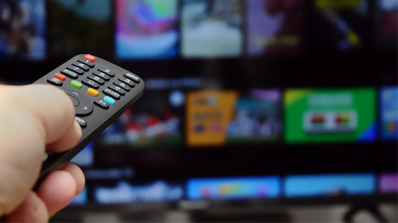 Close up of remote changing channel