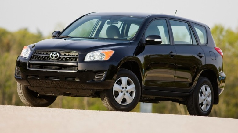 Black 2012 Toyota RAV4 parked on a road.