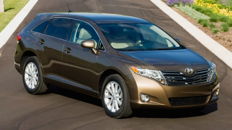 Bronze 2011 Toyota Venza parked on a narrow road.