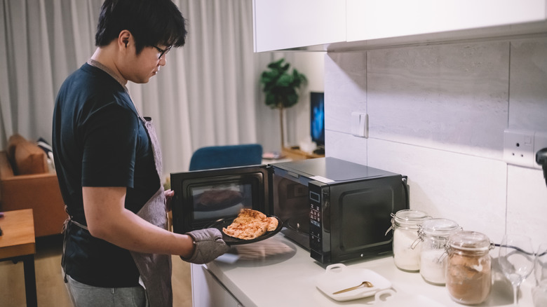 Man using a microwave
