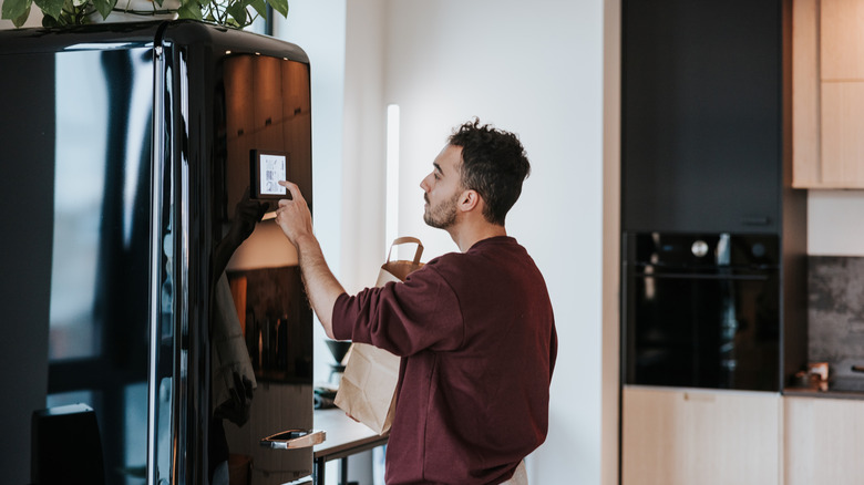 Man changing settings on his refrigerator