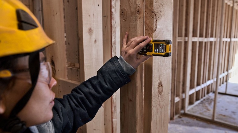 Person using laser measurer
