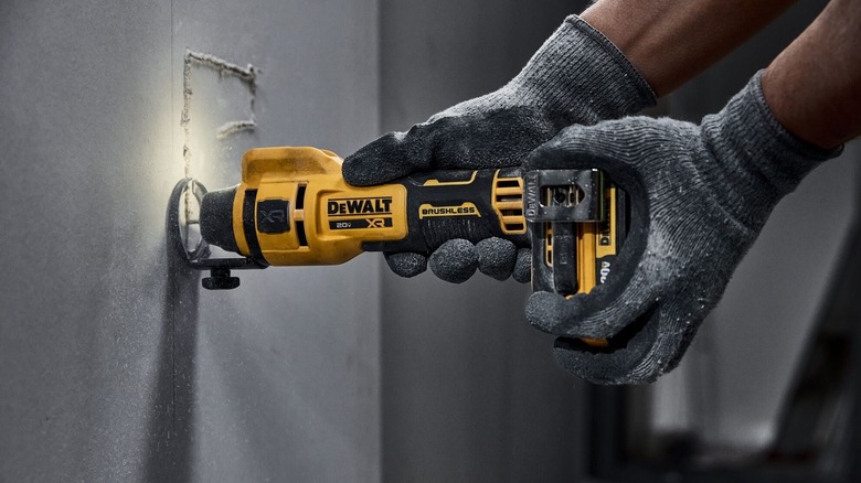 Person using DeWalt drywall cutter