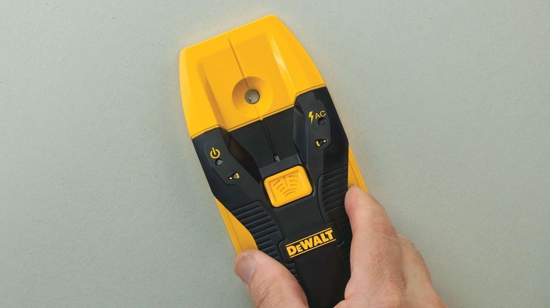 Person using DeWalt stud finder