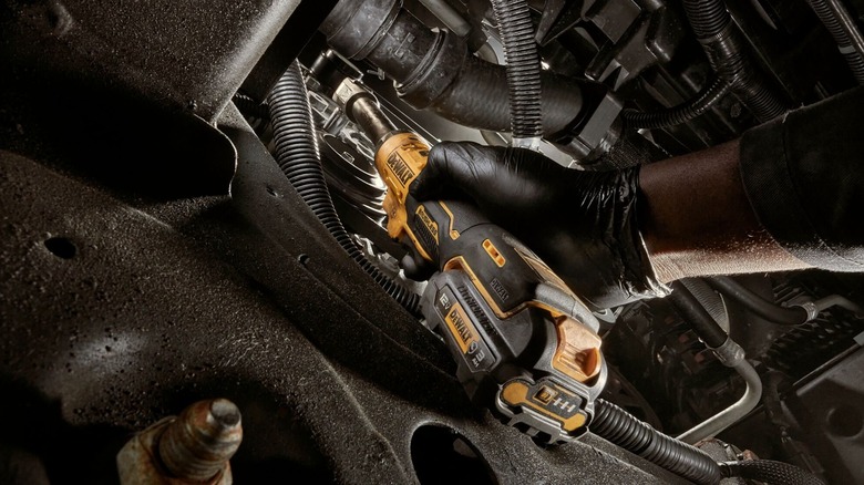 Person using DeWalt powered ratchet wrench
