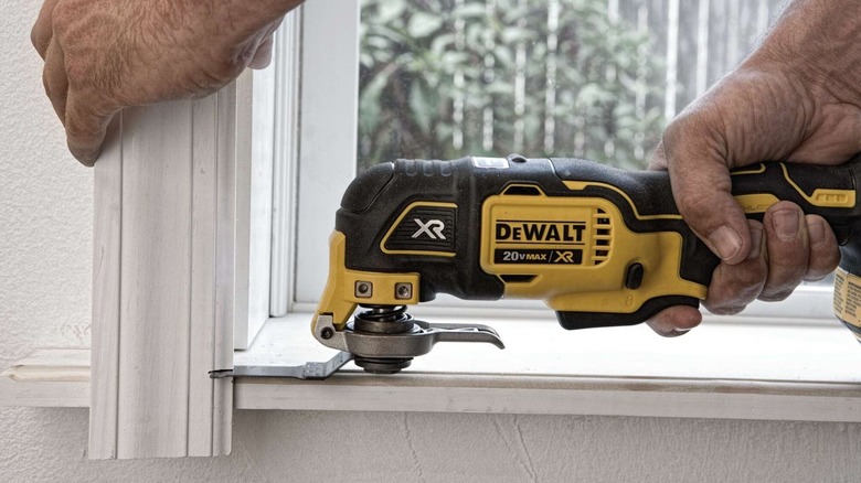 Person using DeWalt multi-tool