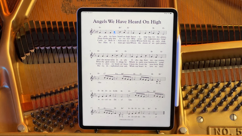 Forscore app on iPad with sheet music, sitting on a grand piano