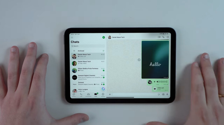 Daniel using WhatsApp on an iPad Mini resting on a table