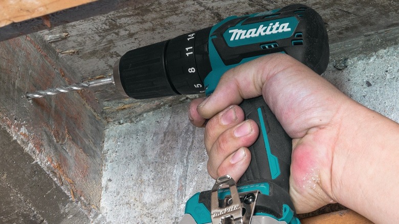 Person using Makita hammer drill