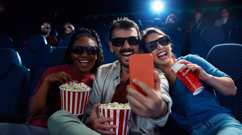 People taking selfies at theatre