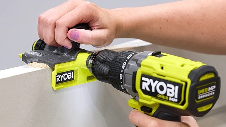 A person using Ryobi door trimmer.