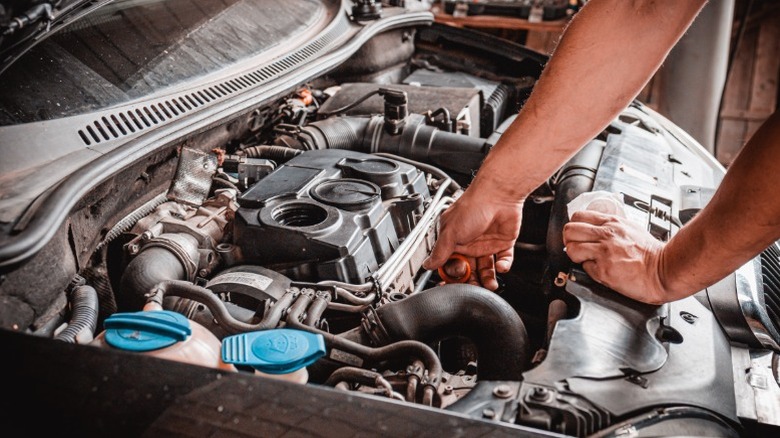 A mechanic working on a car