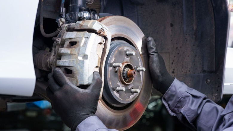 a mechanc checking out a car's breaks