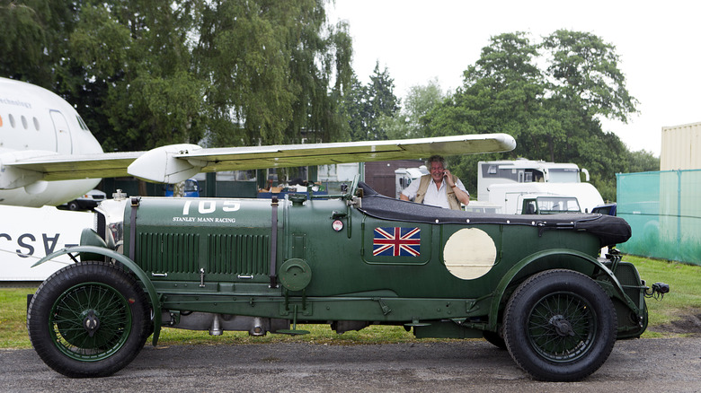 A Bentley 6.5 liter car, fully restored and finished in British Racing Green, parked at the side of a small internal road.