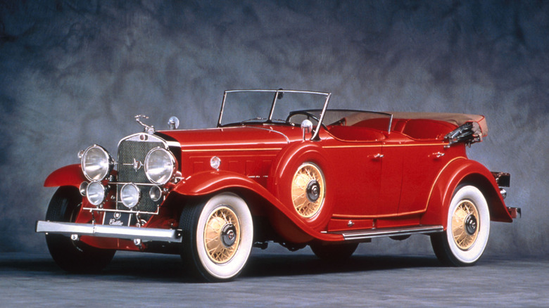 A red Cadillac V-16 previewed in an undated photograph at a Pebble Beach motoring event.