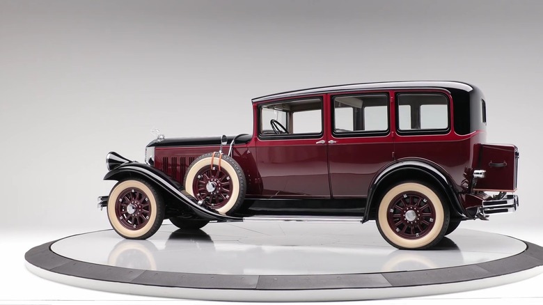 A Pierce-Arrow model 125, known also as the Model 133, in a studio background with red and black bodywork.