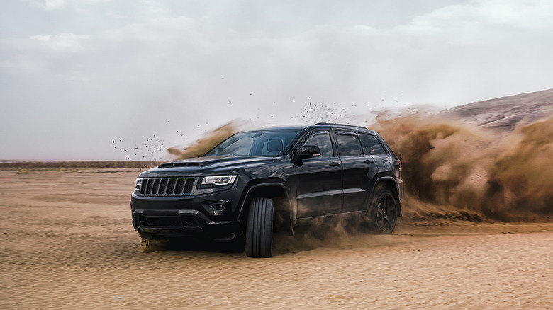 car sliding desert dust cloud
