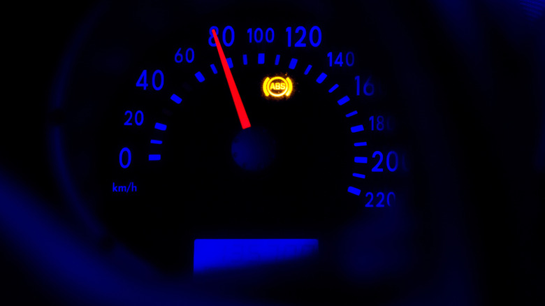 Car instrument panel showing speedometer and ABS light