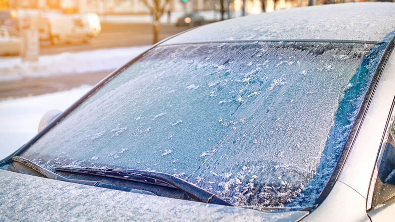 Car windshield completely iced over on an early morning in winter