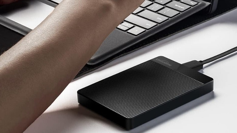UnionSine 750GB 2.5" Ultra Slim Portable External Hard Drive plugged into a laptop.