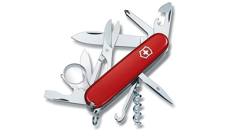 Red Swiss Army Knife multi-tool with tools pulled apart, with white background