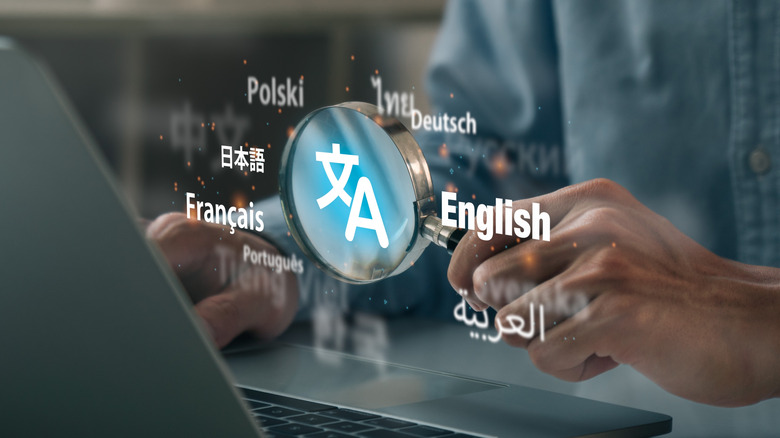 Man hand using magnifying glass to translation of foreign languages on website.