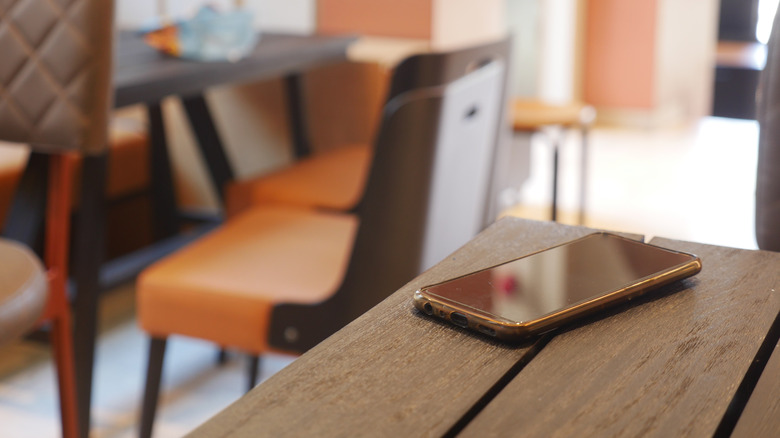 forgotten smartphone on a café table.