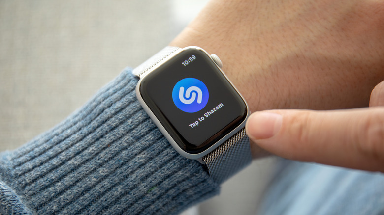 Man hand with Apple Watch Series 4 and music service Shazam on the screen.