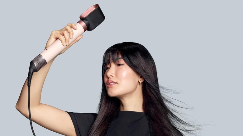Woman holding a hair dryer