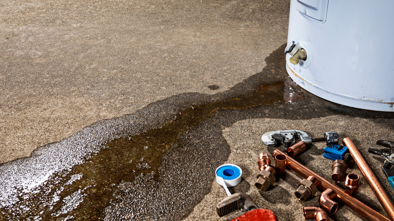 A water heater leaking water on concrete
