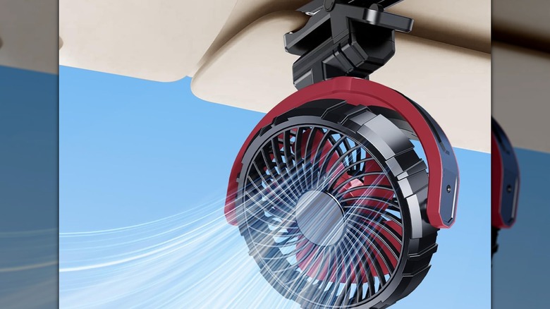 Red and black fan clipped on to a car sun visor