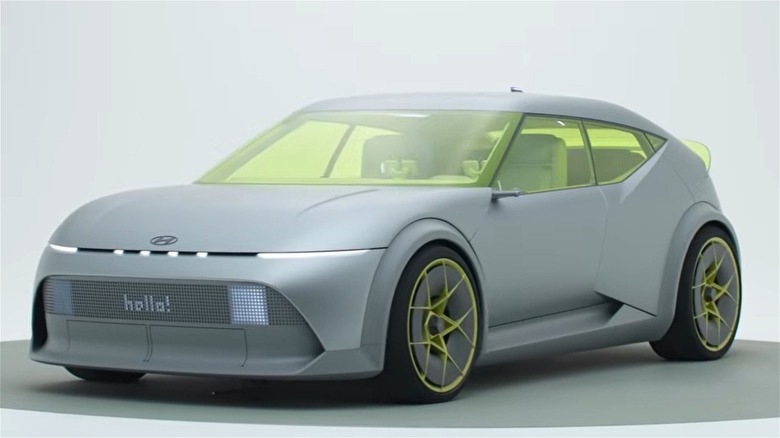 The prototype version of the 2026 Hyundai Ioniq 3 showing off its flair in a showroom with a white background.