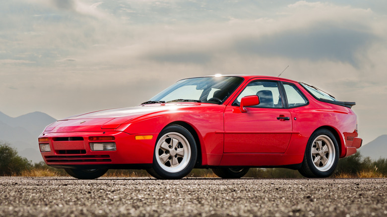 A red Porsche 944 Turbo parked outside in the desert