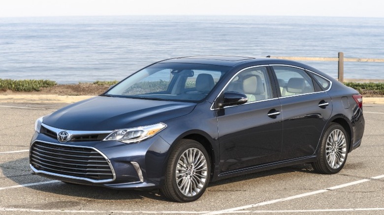 Black 2017 Toyota Avalon parked with sea in the background