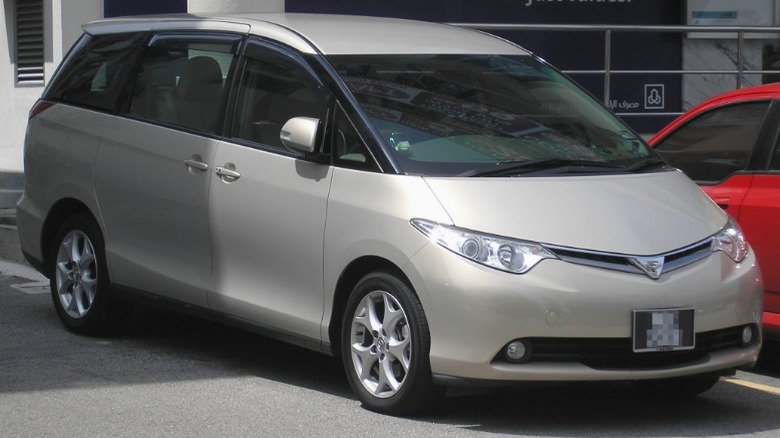 Silver Toyota Estima parked in front of a building