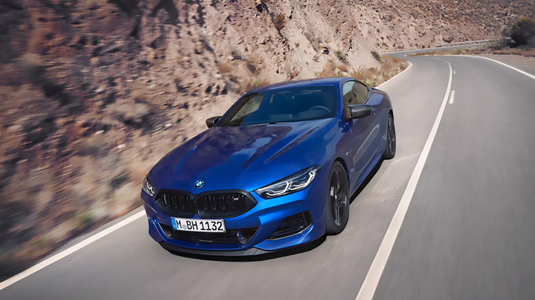 A blue BMW 8 Series driving