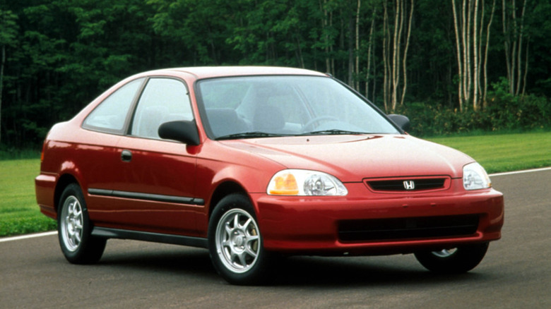 A red Honda Civic parked on a roadway.