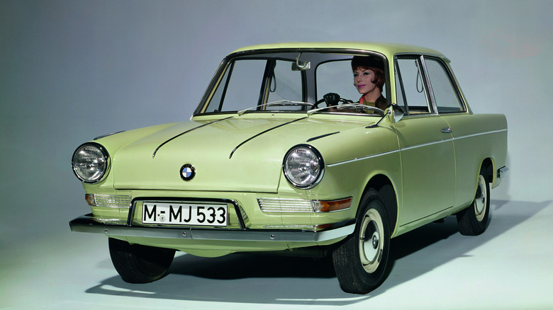 Tan BMW 700 coupe seen from front left in a studio
