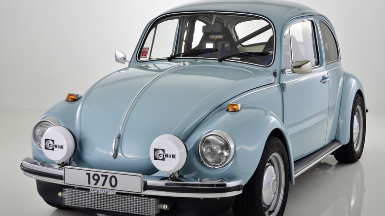 Light blue 1970 Volkswagen Beetle seen from front left in studio