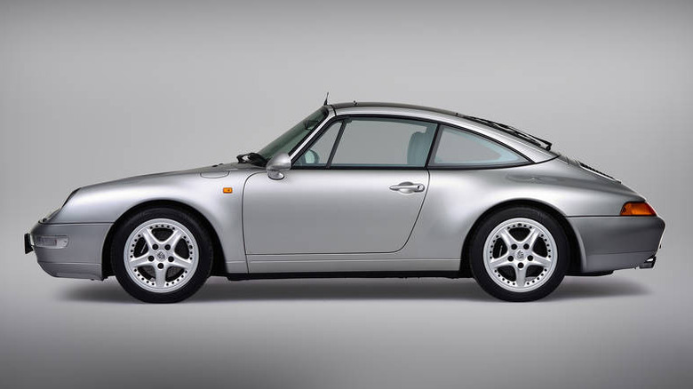 Silver 1998 Porsche 911 Targa 993 seen from left in studio
