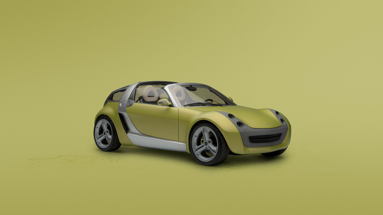 Gold 2003 Smart Roadster seen from right front against a gold studio background