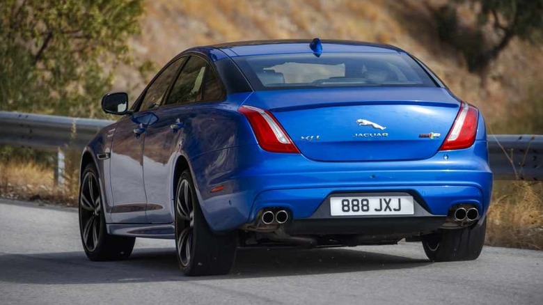 Rear 3/4 view of a blue Jaguar XJ