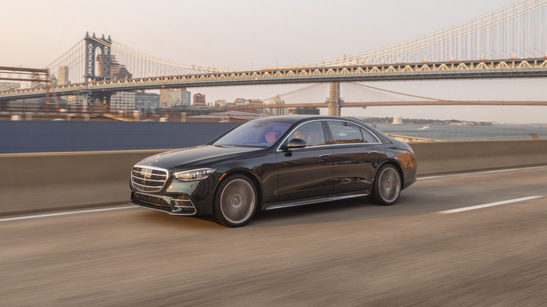 A Mercedes S Class on the road, seen from the side.