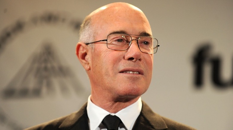 David Geffen with a black tie and glasses on.