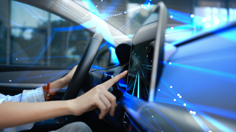 Driver interacting with high-tech car dashboard