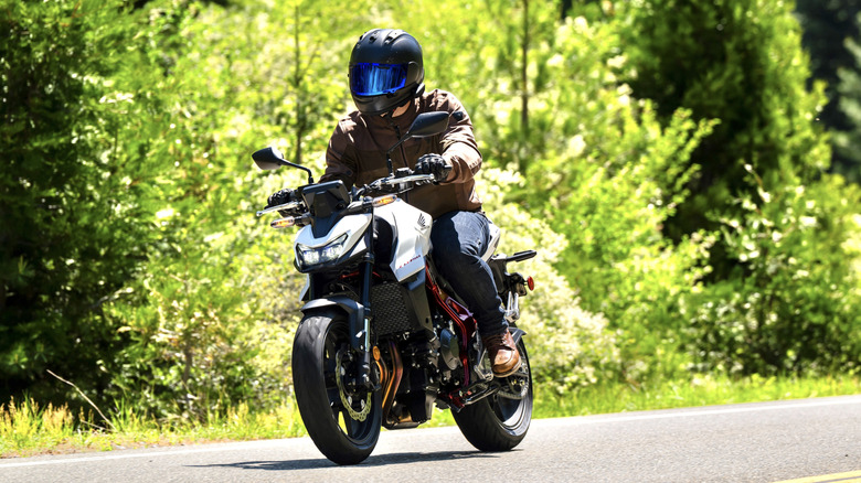 Honda CB750 Hornet being ridden on a back-country road