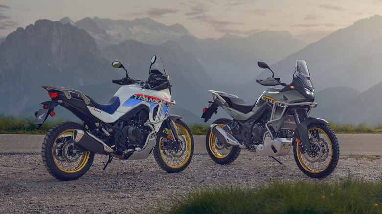 Two Honda XL750 Transalp motorcycles parked near mountains