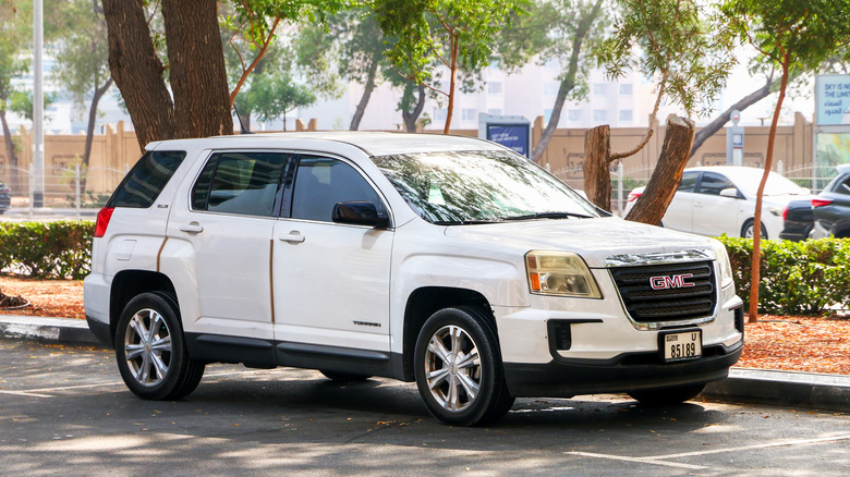 A white GMC Terrain, albeit an older model, parked at the side of a street