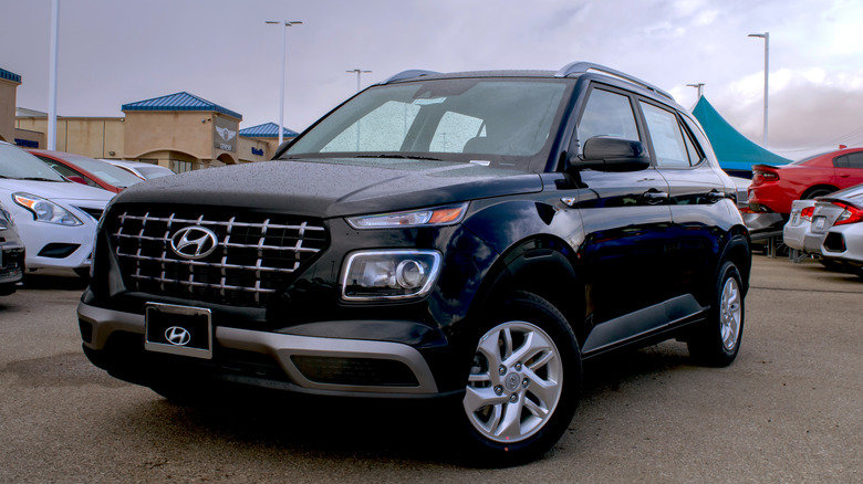 A jet black 2020 Hyundai Venue on display in a dealer lot in Victorville, California
