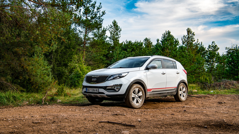 A 2020 Kia Sportage on an offroad track in the middle of the forest